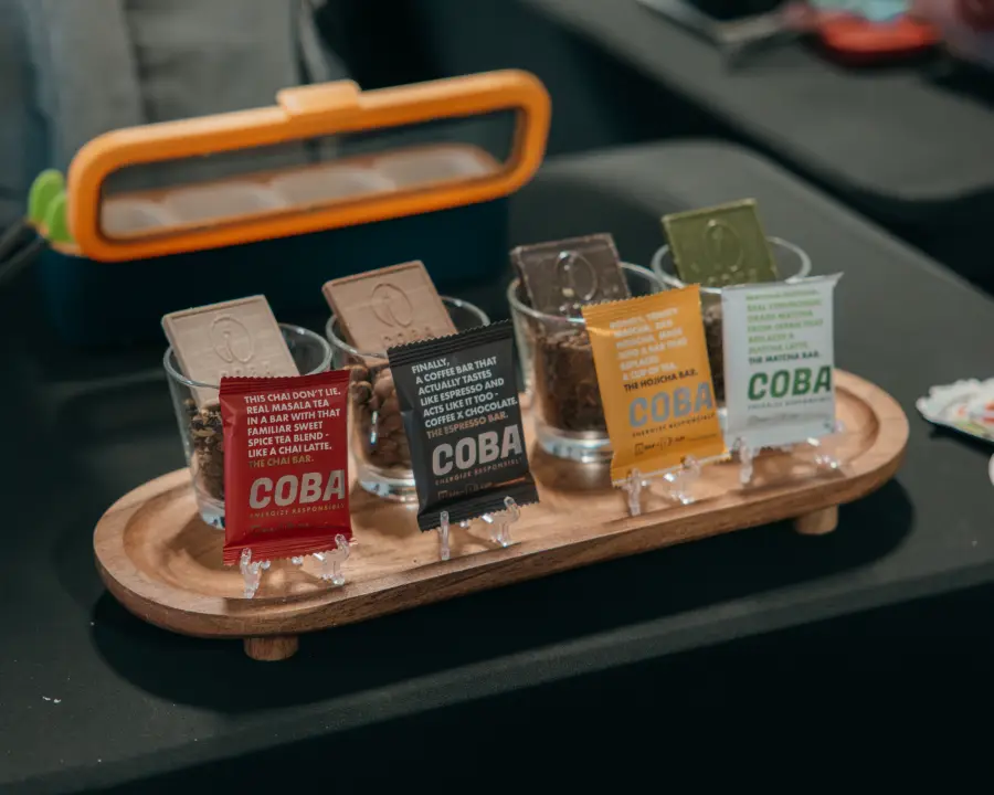 COBA coffee and chai bars displayed on a wooden tray